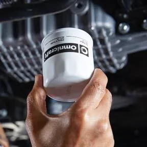 Oil filter being installed during routine vehicle maintenance